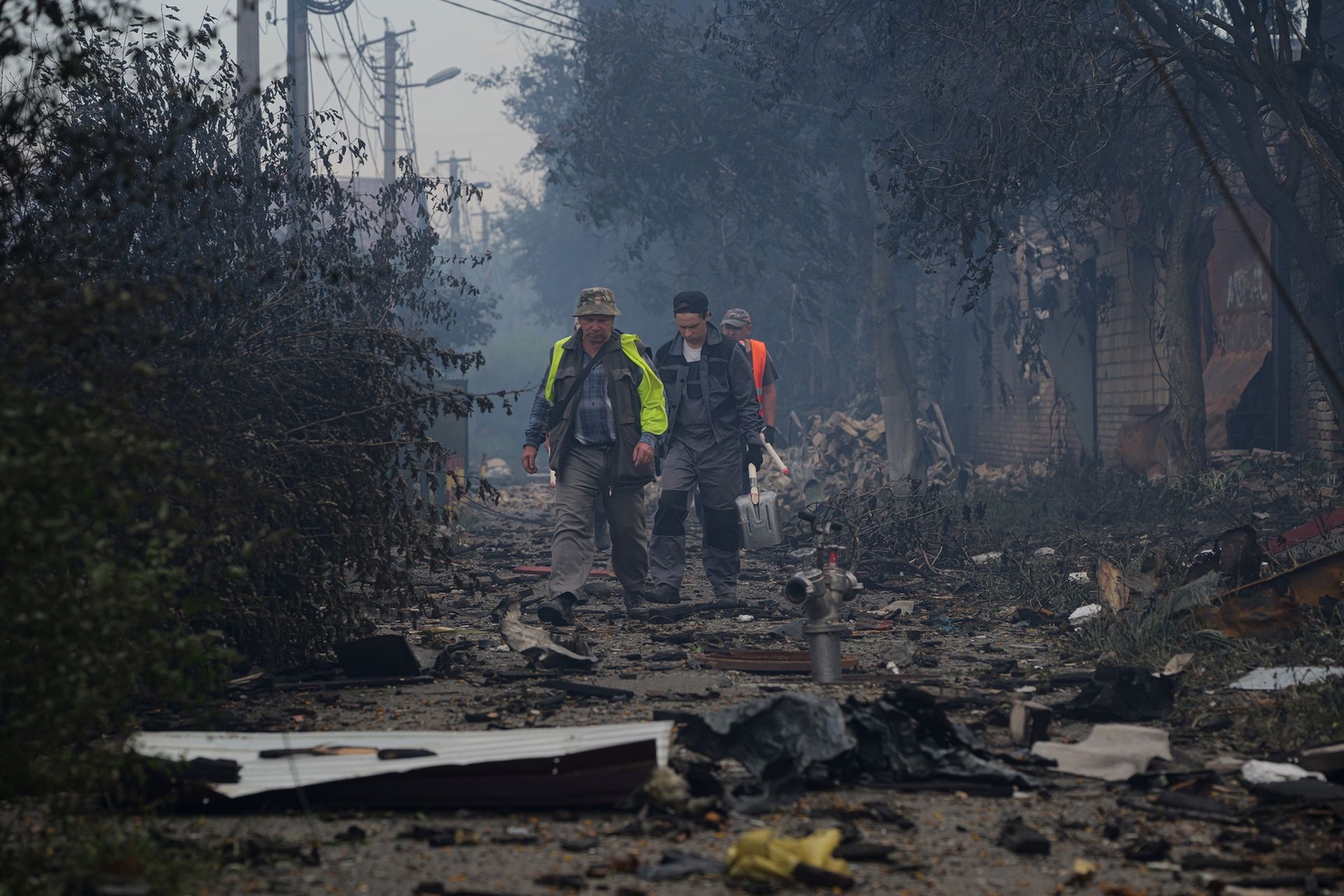 People walk through a debris-strewn street following the Russian attack in Vyshneve, Kyiv Oblast, Ukraine, on July 6, 2026.