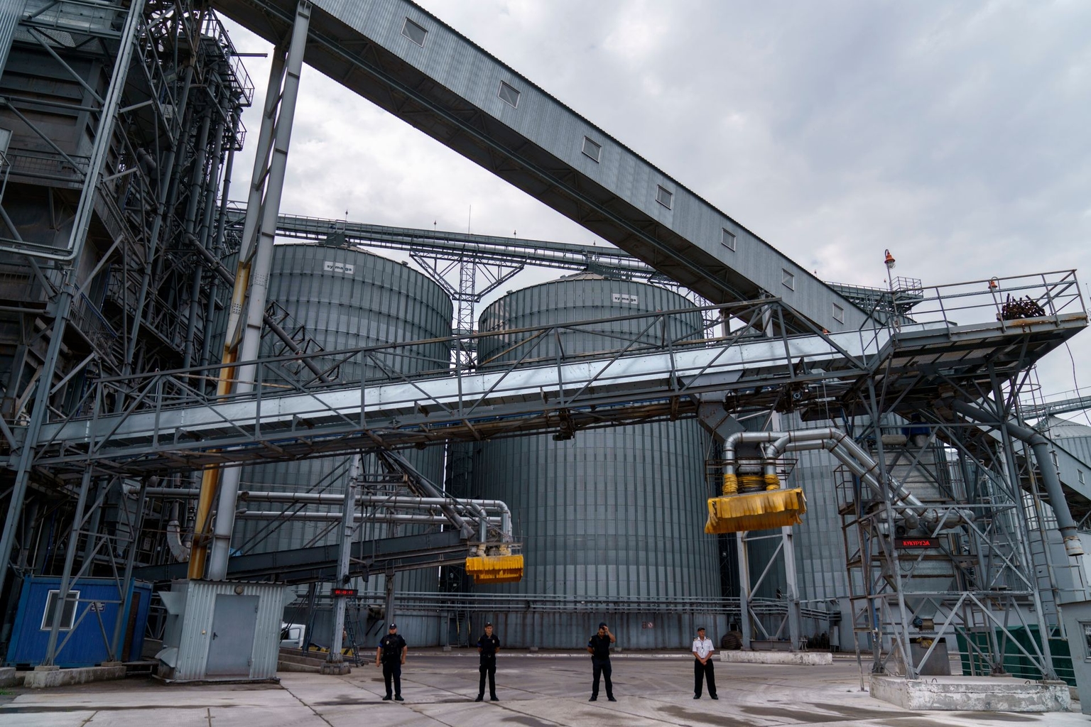 A person walks past a grain storage terminal at the Odesa Sea Port in Odesa, Ukraine, on July 29, 2022.