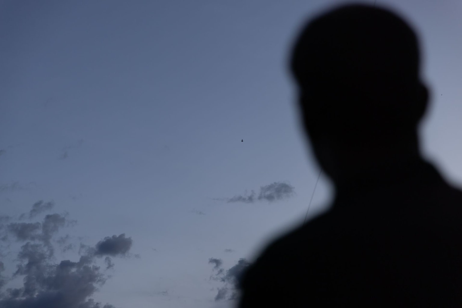 A Ukrainian serviceman watches a P1-Sun interceptor drone fly in Kharkiv Oblast on May 20, 2026.