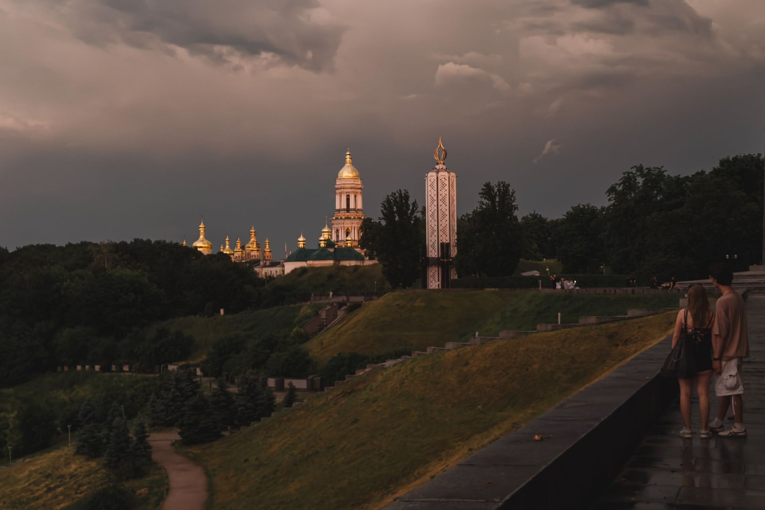 A man and a woman look toward the Kyiv Pechersk Lavra after a thunderstorm in Kyiv, Ukraine, on June 29, 2026.