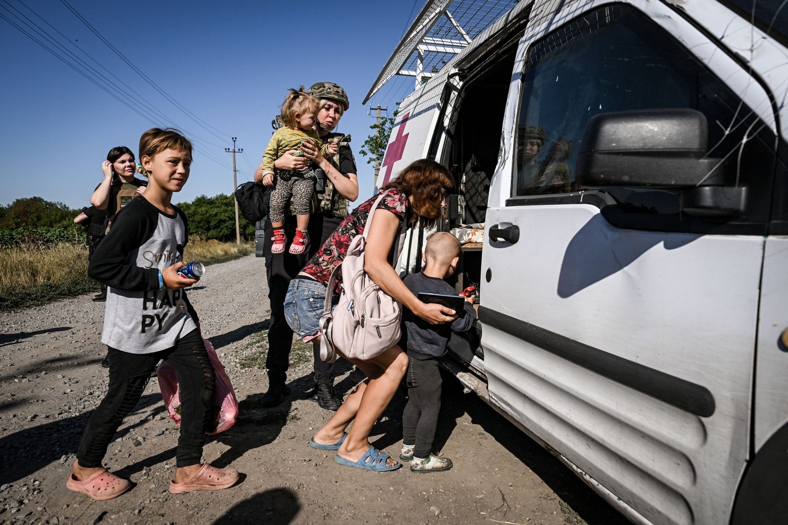 A woman and her children get into a van during an evacuation in Novoivanivka, Ukraine, on July 31, 2026.