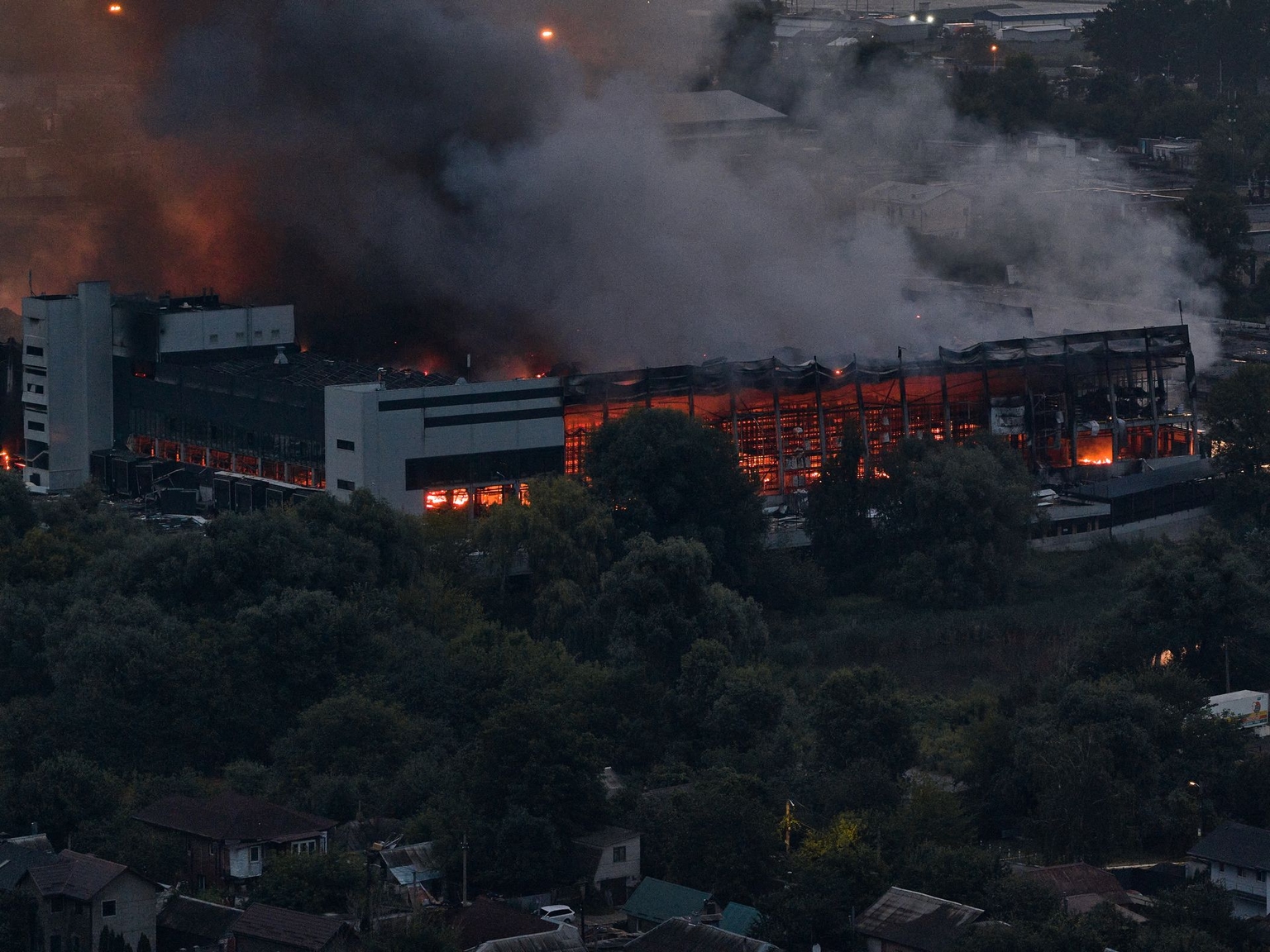 An aerial view shows a massive column of smoke rising above Kyiv from a burning Novus supermarket chain warehouse following a Russian ballistic missile attack on the capital, in Kyiv, Ukraine, on Aug. 5, 2026.