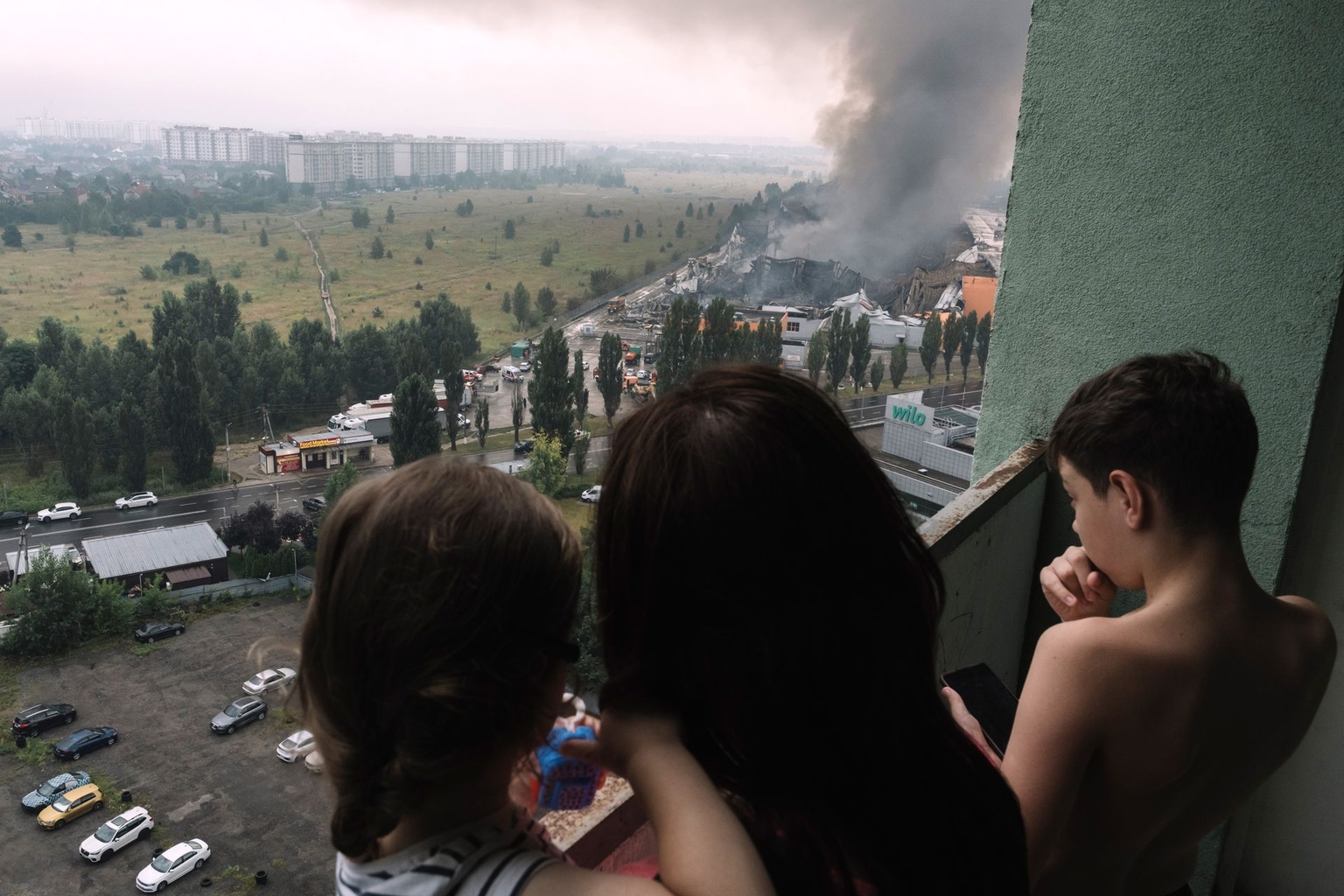 Residents look at the scene following a Russian missile strike on a goods storage area in Kyiv, Ukraine, on Aug. 5, 2026.