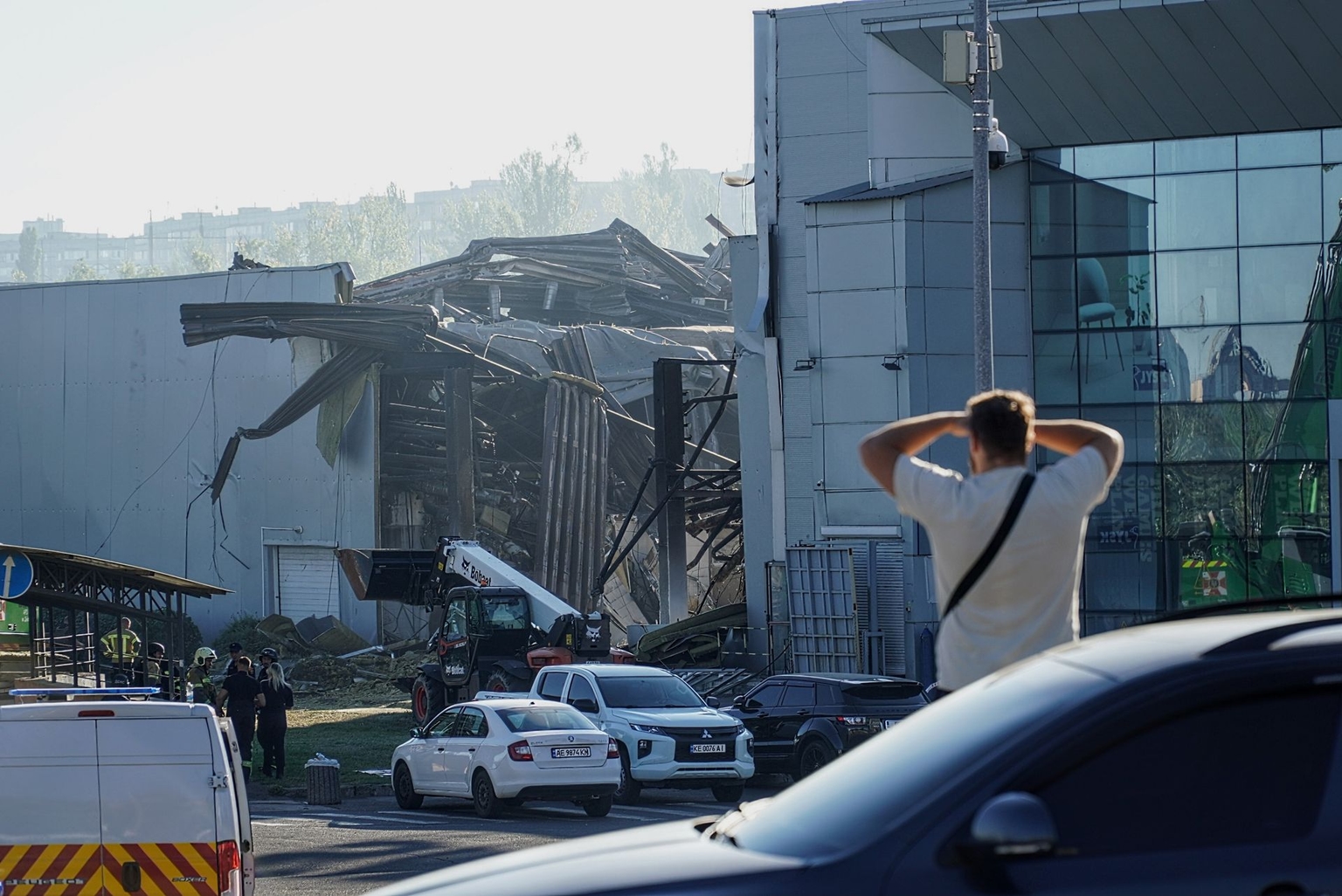 A man looks at a shopping center damaged by a Russian drone strike in Kryvyi Rih, Ukraine, on Aug. 22, 2026.