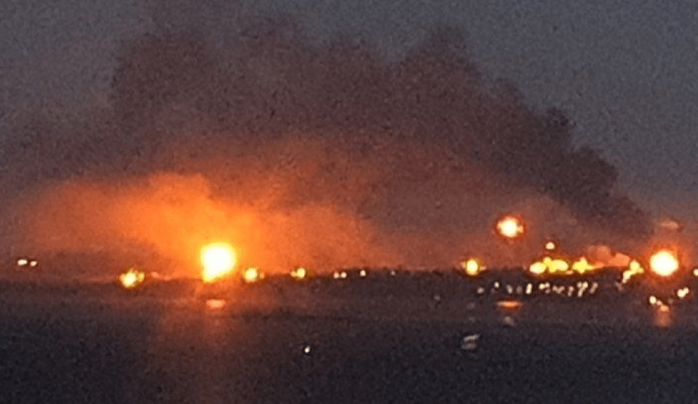 Three bright fires in the distance under a night sky