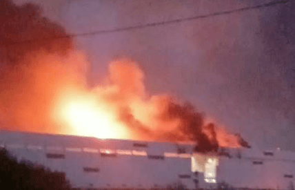 A fire burns at a warehouse