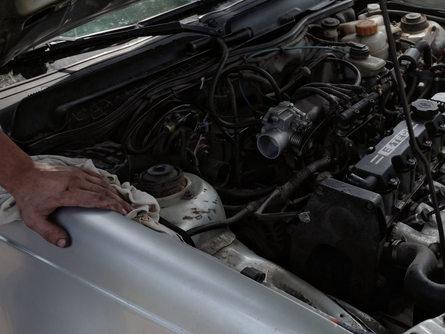 A local resident repairs his car in Pavlohrad, Ukraine, on August 15, 2026.
