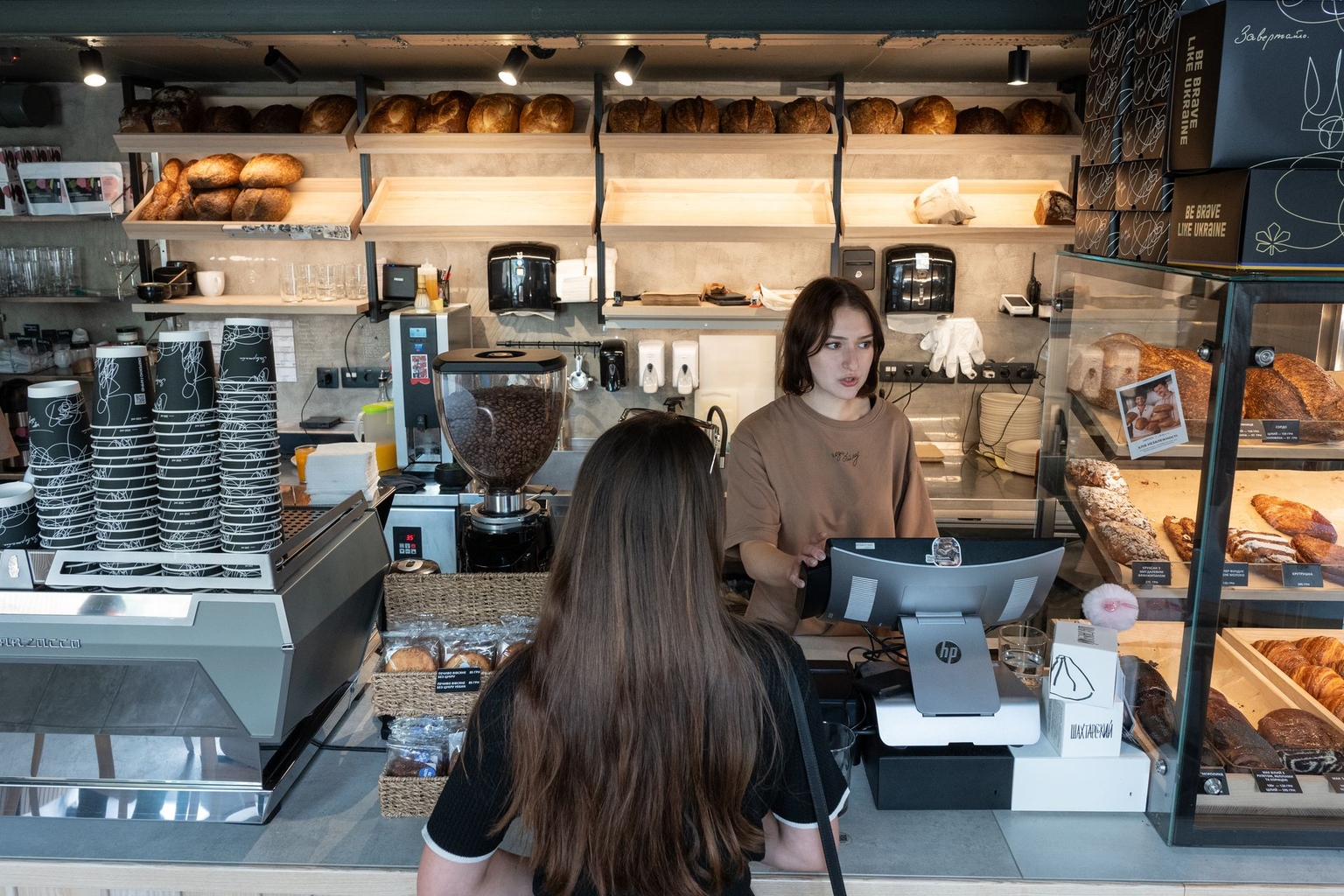 A woman orders coffee at the Zavertaylo cafe in Kyiv, Ukraine on Sept. 8, 2026.