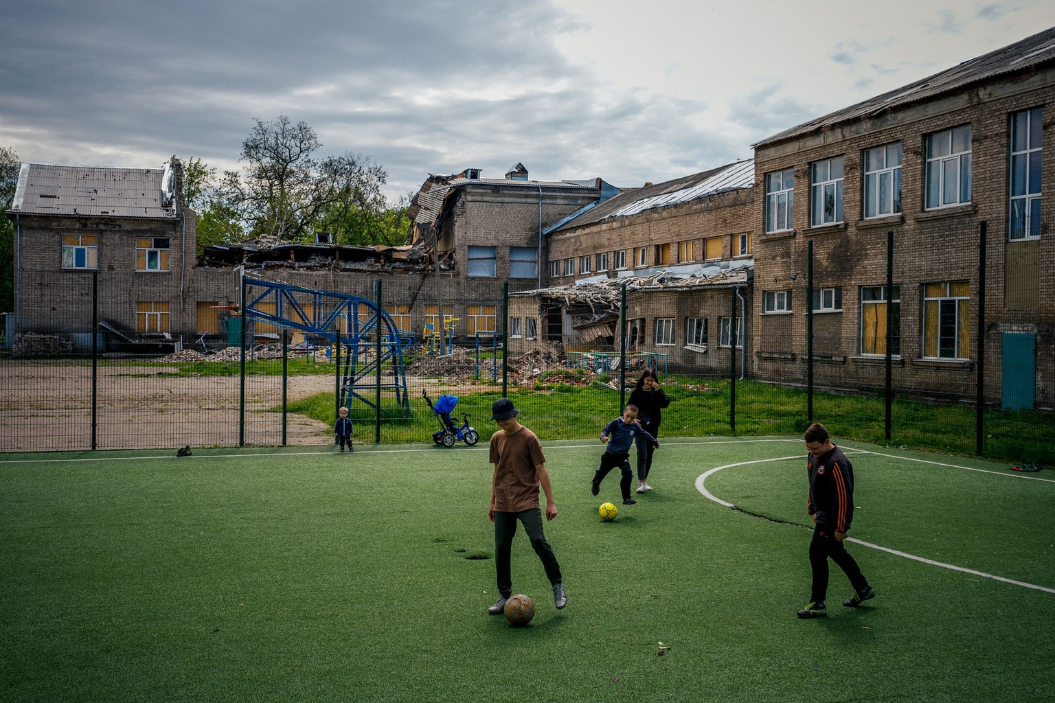 Children play soccer next to a damaged building following shelling in Kramatorsk, Donetsk Oblast, Ukraine, on May 6, 2023.