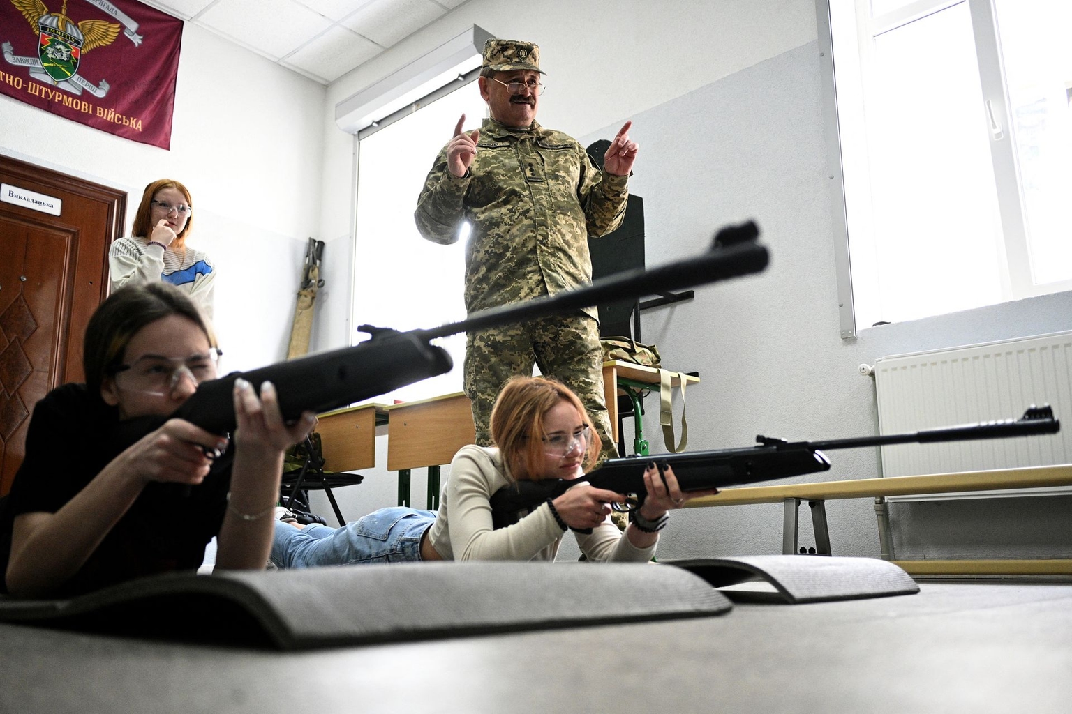 Students practice shooting at a digital shooting range at the Kyiv Cadet Corps Volodymyr Velykyi school in Kyiv, Ukraine, on Sept. 12, 2025.