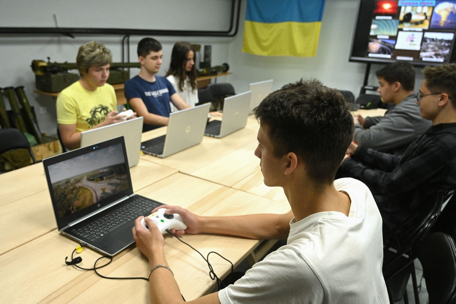 Schoolchildren learn to fly a drone using simulators during a lesson at a military-patriotic center in Lviv, Ukraine, on Sept. 14, 2023.
