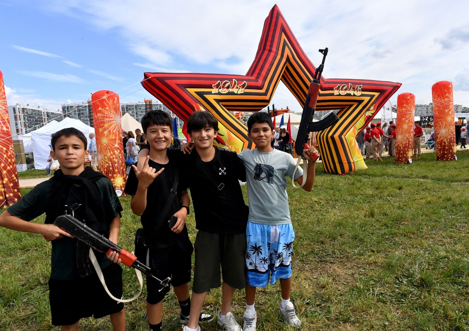 Children pose with mock weapons during the Russian Agricultural Festival in Murino, Leningrad Oblast, Russia, on Aug. 8, 2025.