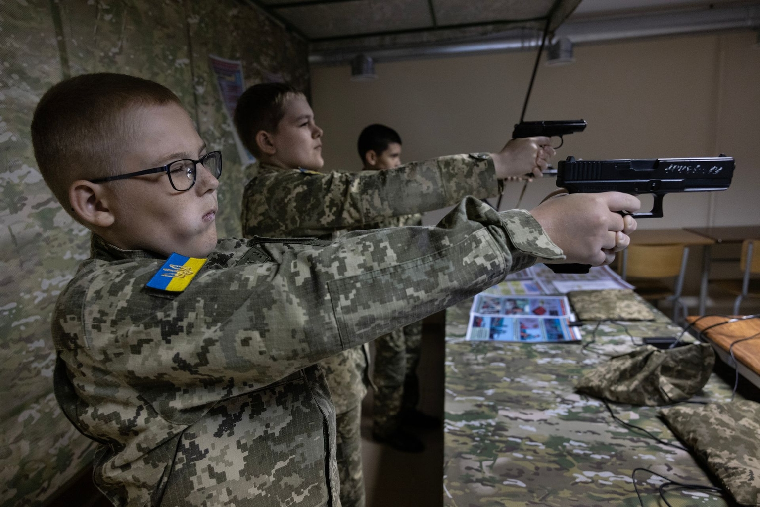 Students practice shooting at a digital shooting range at the Kyiv Cadet Corps Volodymyr Velykyi school in Kyiv, Ukraine, on Sept. 12, 2025.