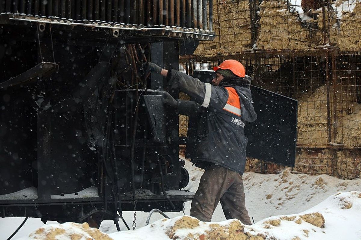 A worker from does repair work at an energy facility damaged in a Russian strike in Kharkiv, Ukraine.