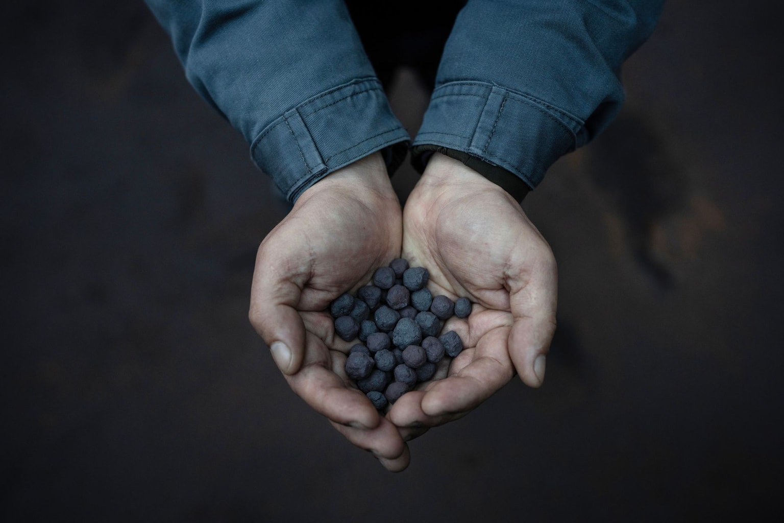 Employee shows processed iron ore at a plant in Kryvyi Rih, Ukraine, on April 14, 2026.