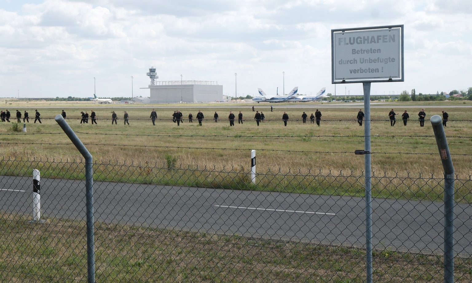 Police officers search a field near Leipzig-Halle Airport in Schkeuditz, Germany, on Aug. 7, 2026.