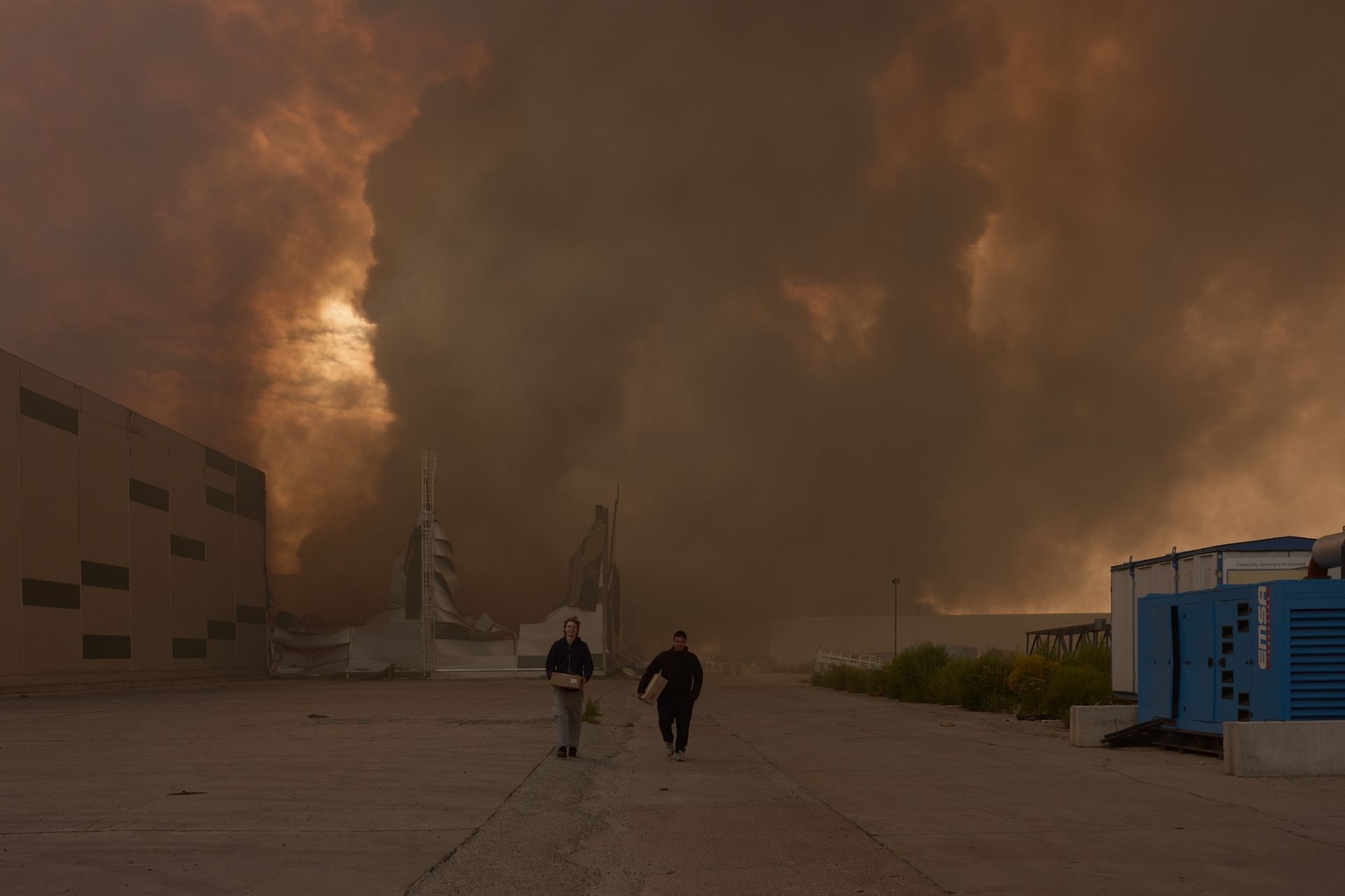 Civilians at the location of the massive fire at a commercial warehouse following a Russian drone strike in Boryspil, Kyiv Oblast, Ukraine, on Aug. 27, 2026.