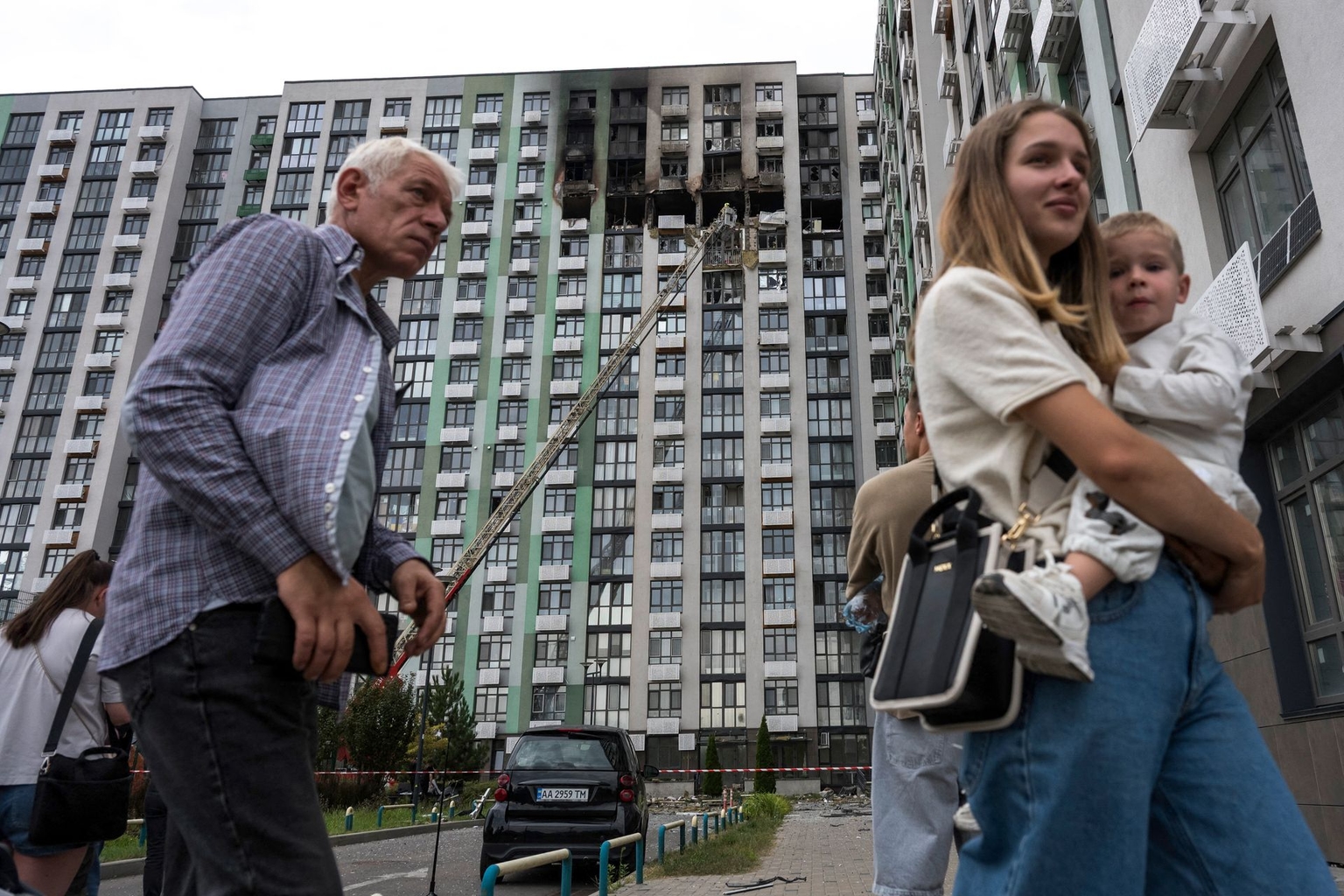 Local residents walk past a heavily damaged residential building following a Russian strike in Kyiv, Ukraine, on Sept. 1, 2026.