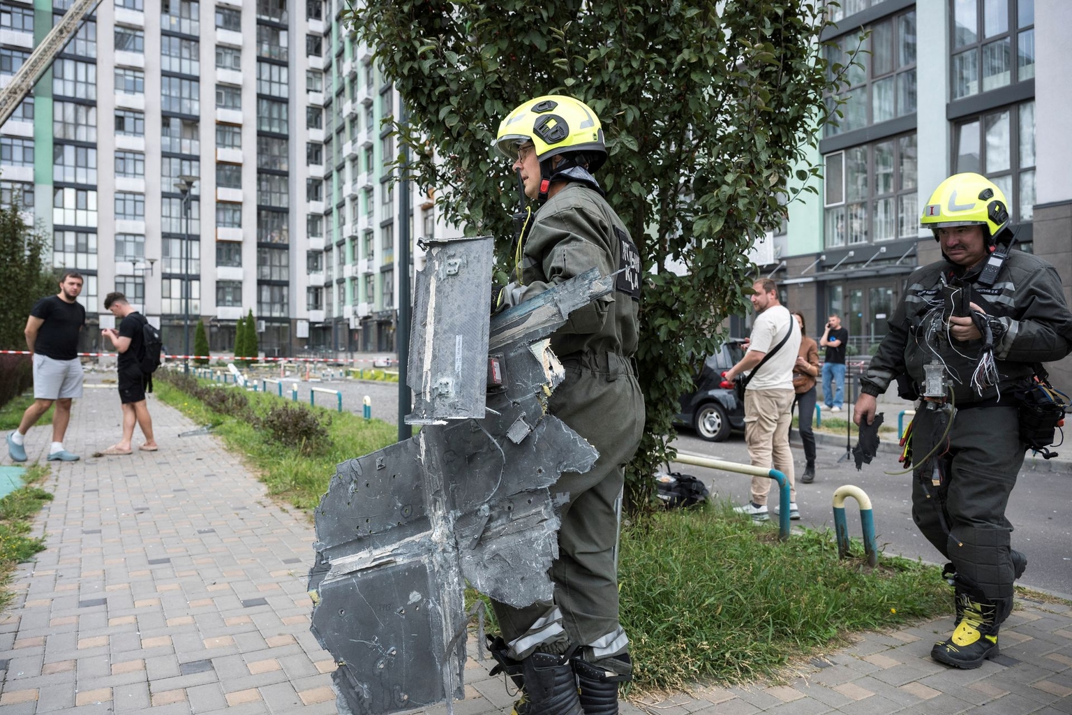A rescuer carries part of the wreckage of an alleged Russian drone following a Russian strike in Kyiv, Ukraine, on Sept. 1, 2026.