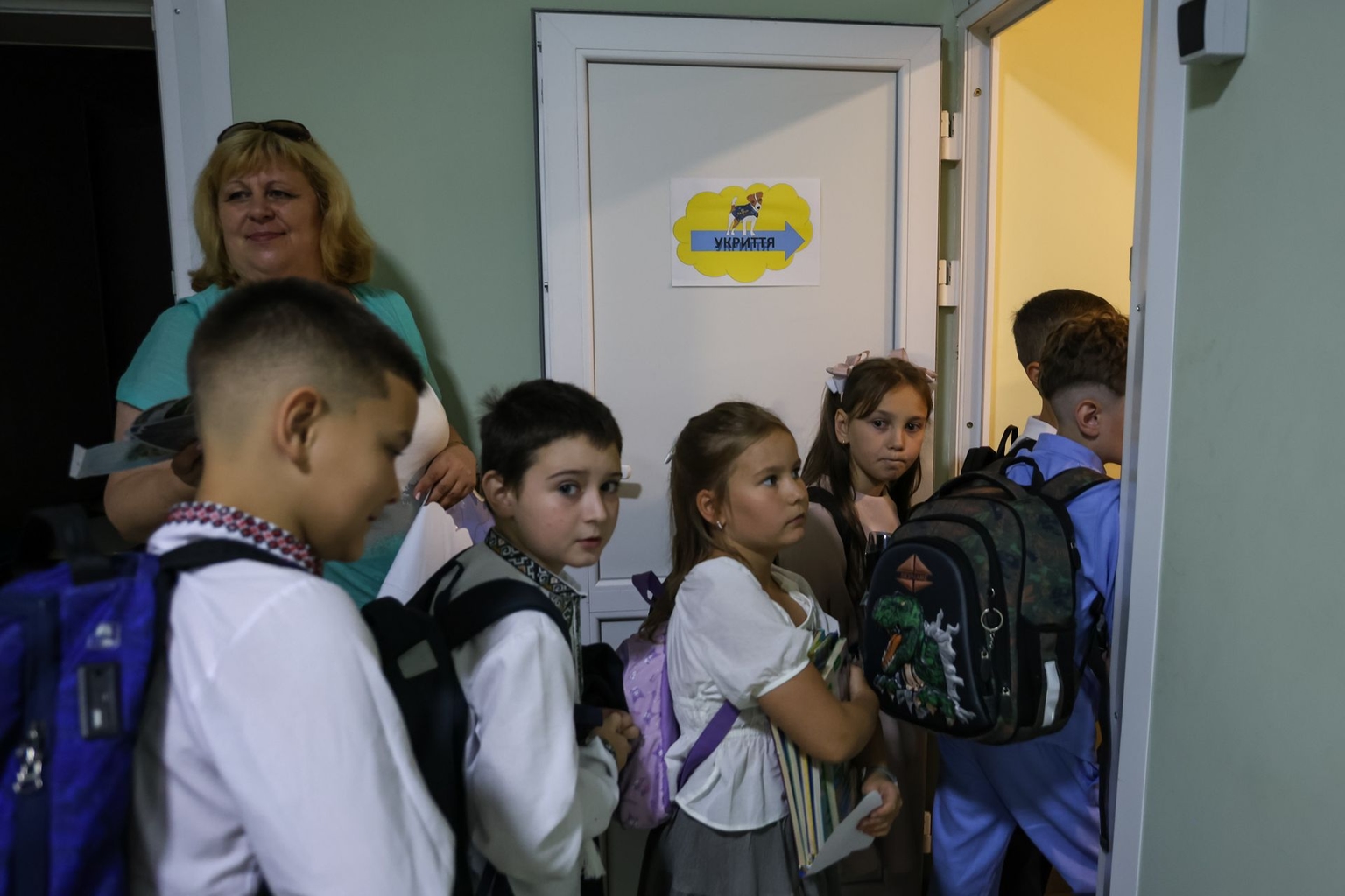 Children go down to a shelter at school in Kyiv, Ukraine, on Sept. 1, 2026.