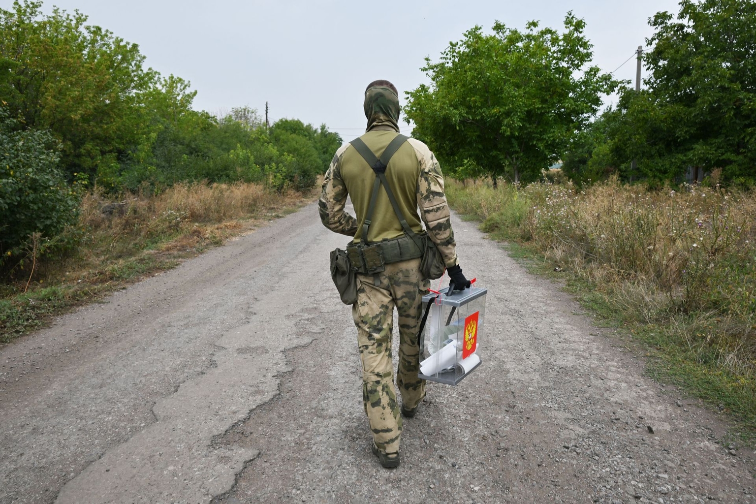 A Russian serviceman carries a mobile ballot box in Verbivka, Russian-occupied Donetsk, Ukraine, on September 14, 2026.