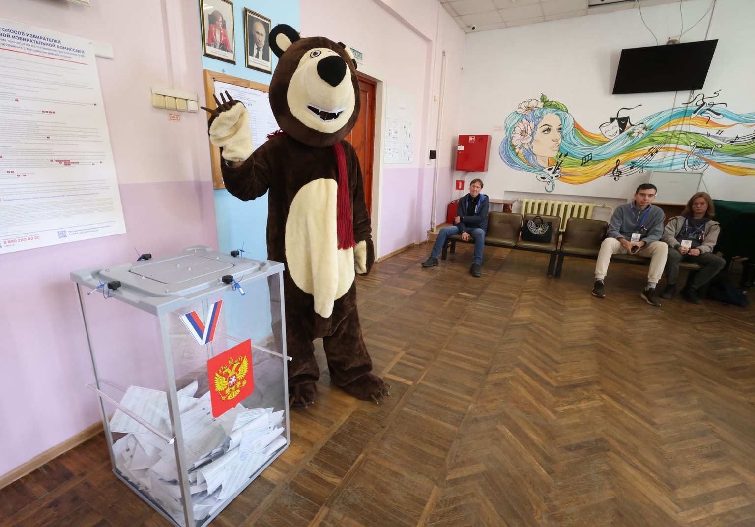 A man in a bear costume greets residents at a polling station in Istra, Russia, on September 19, 2026.