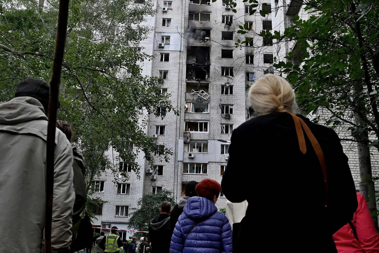 People gather at the site of an apartment building hit by a Russian jet drone strike in Kyiv, Ukraine, on Sept. 25, 2026.