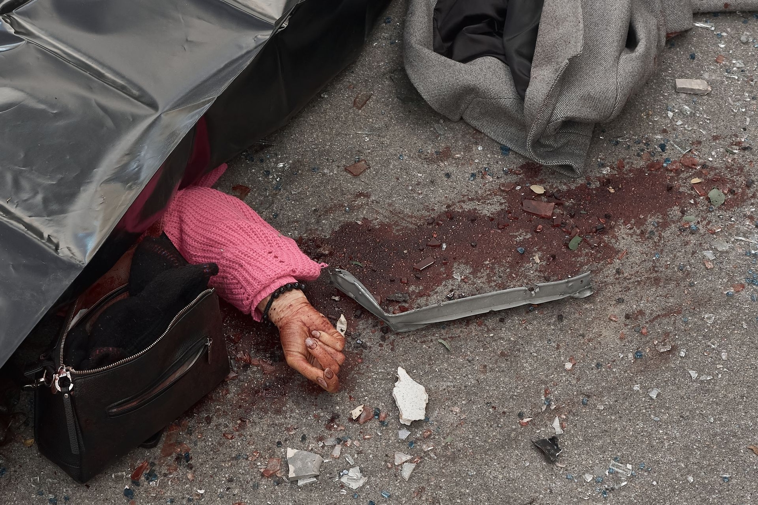 A woman killed in a drone strike lies in the street in Kyiv, Ukraine, on Sept. 25, 2026.