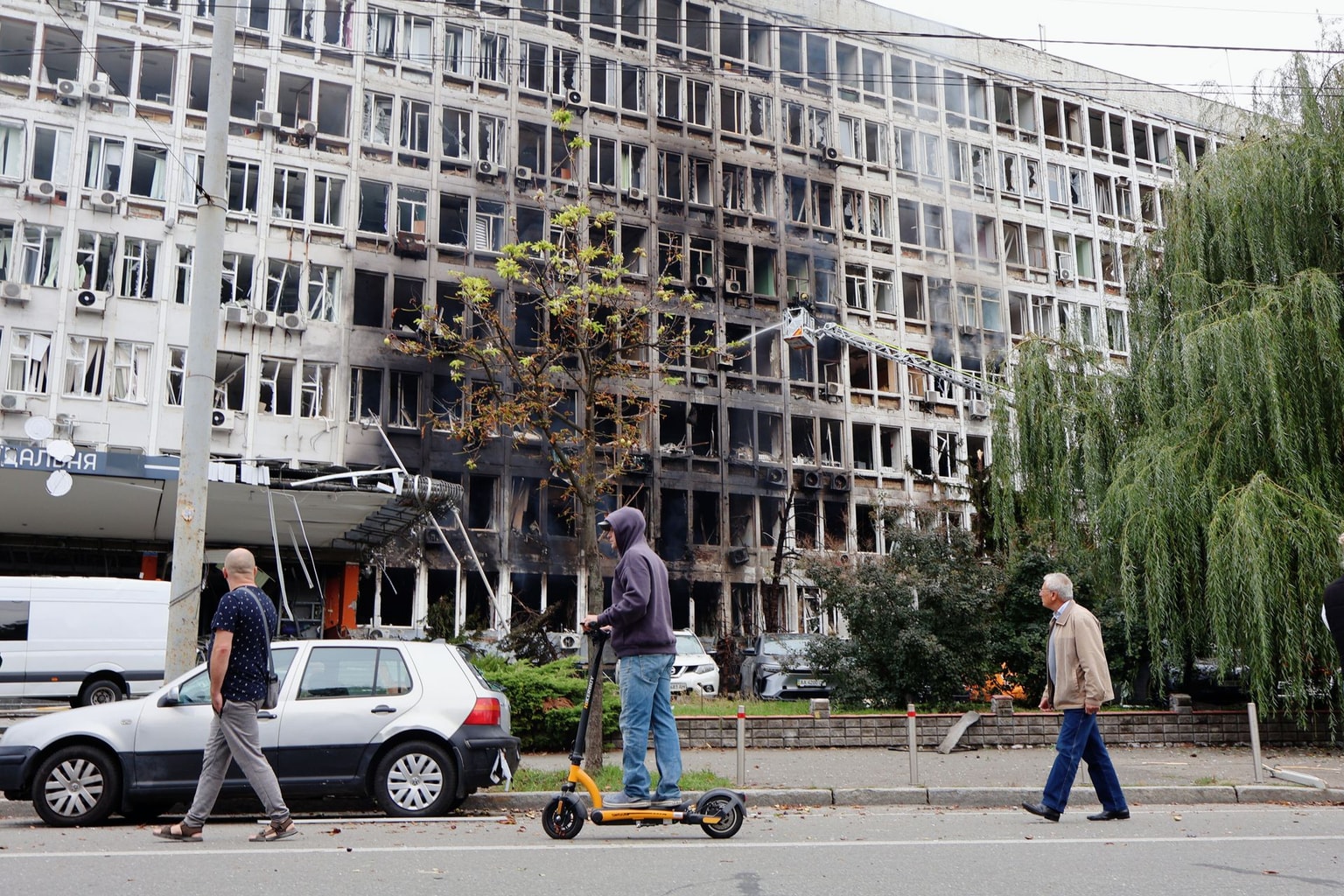 People walk past a building damaged by a Russian drone strike in Kyiv, Ukraine, on Sept. 23, 2026.