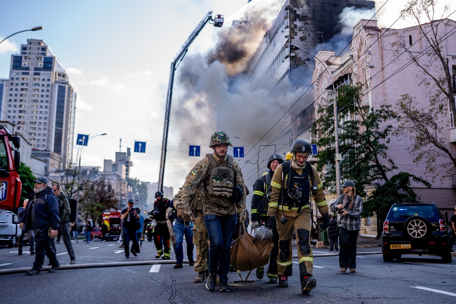 Firefighters and medics evacuate an injured person in Kyiv, Ukraine, on Sept. 28, 2026.