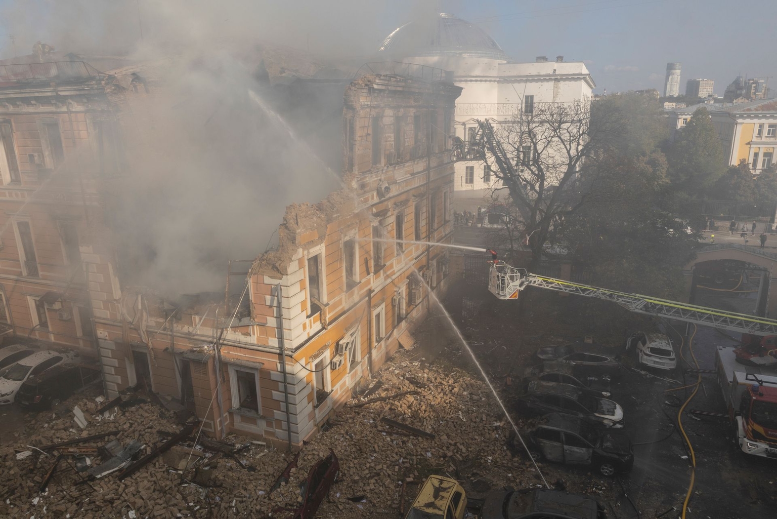 Emergency services attend a drone strike site in central Kyiv, Ukraine, on Sept. 28, 2026.