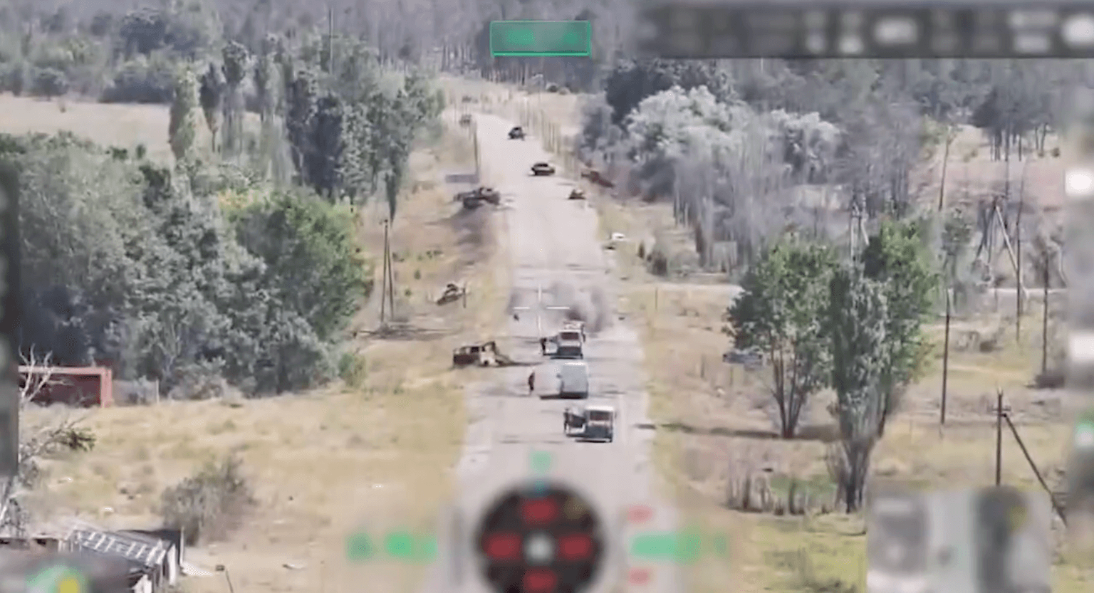 An aerial view of a road in Oleshky, a Russian-occupied town in Kherson Oblast, Ukraine, with vehicles carrying food and supplies attacked by drones