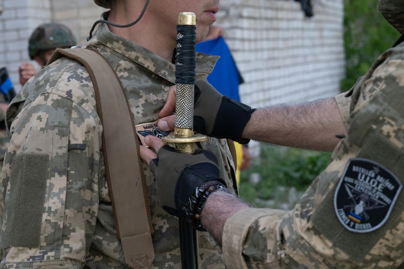 Colonel Jose David Chaparro puts a patch on a soldier in Mykolaiv Oblast, Ukraine, in May 2026.
