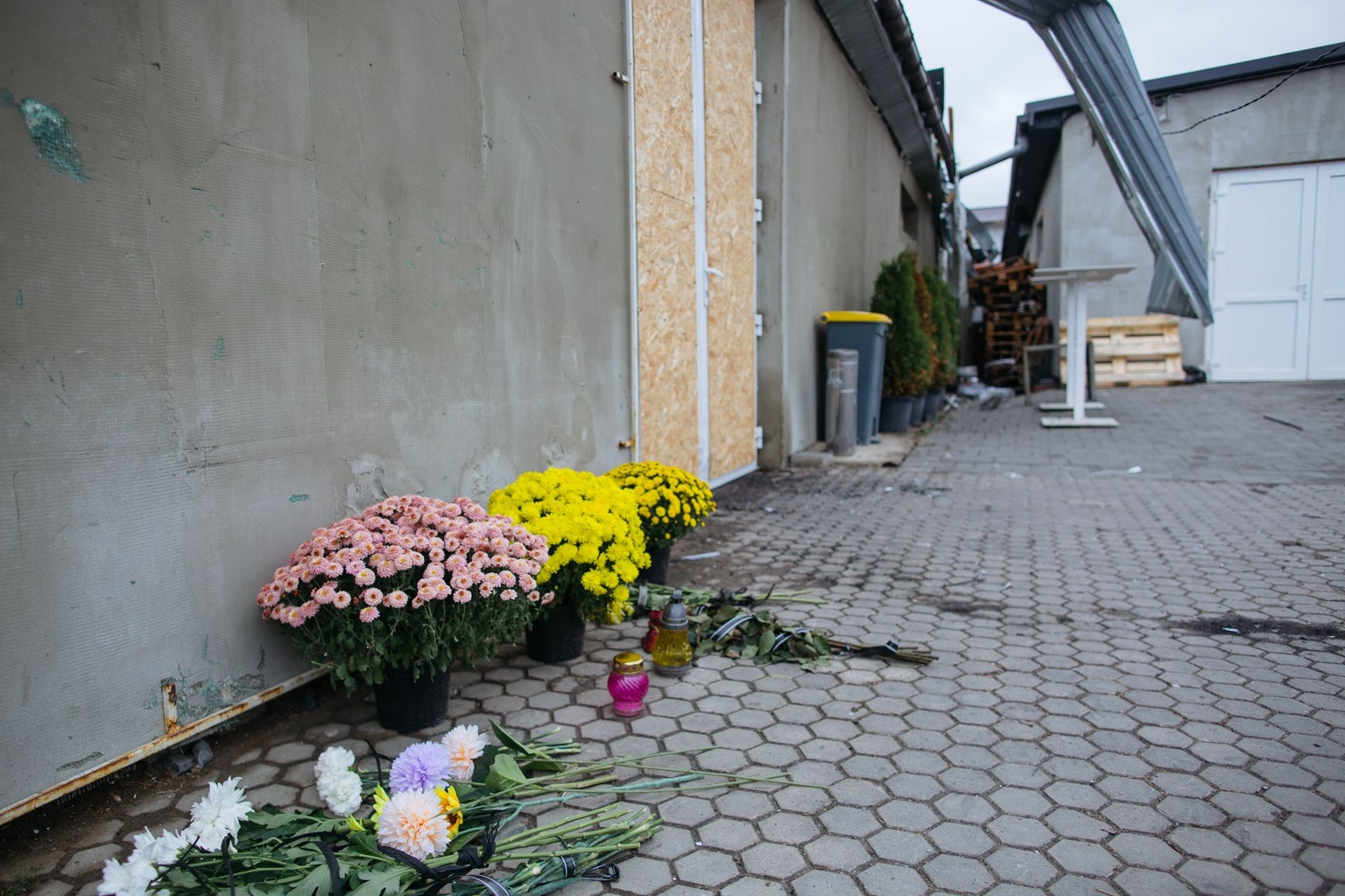 Flowers honor victims in front of a destroyed wholesale store in Lutsk, Volyn Oblast, Ukraine, on Oct. 22, 2026.