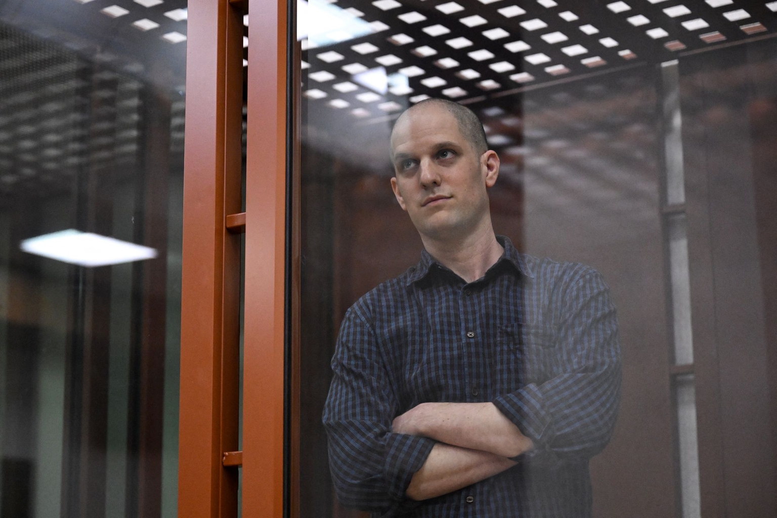 Gershkovich looks out from a glass defendants’ cage in a courtroom in Yekaterinburg, Russia, on June 26, 2024.