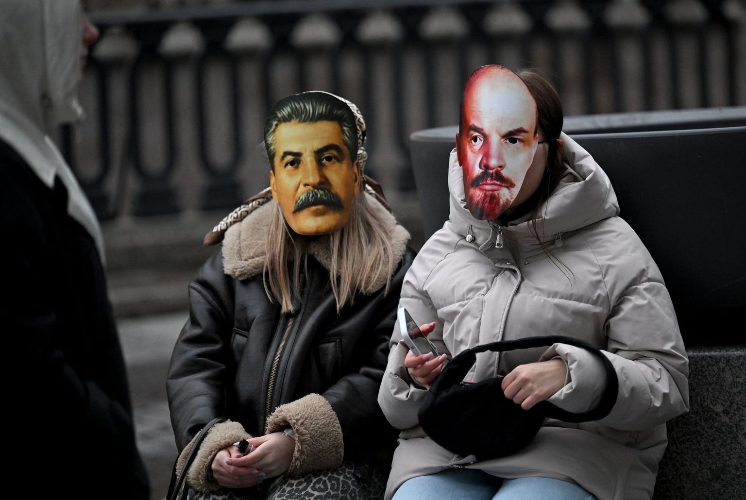 Women wearing masks of Stalin and Lenin attend a concert in Saint Petersburg, Russia, on Oct. 27, 2025.