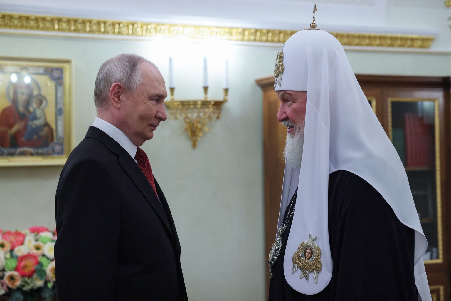 Russian President Vladimir Putin (L) congratulates Russian Orthodox Patriarch Kirill (R) in Moscow, Russia, on May 24, 2026.