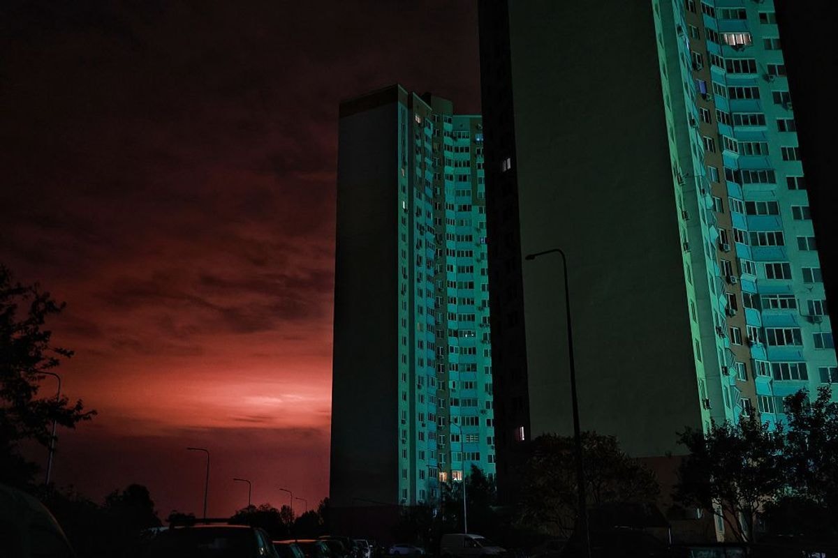 Multi-story residential buildings stand dark in Kyiv.