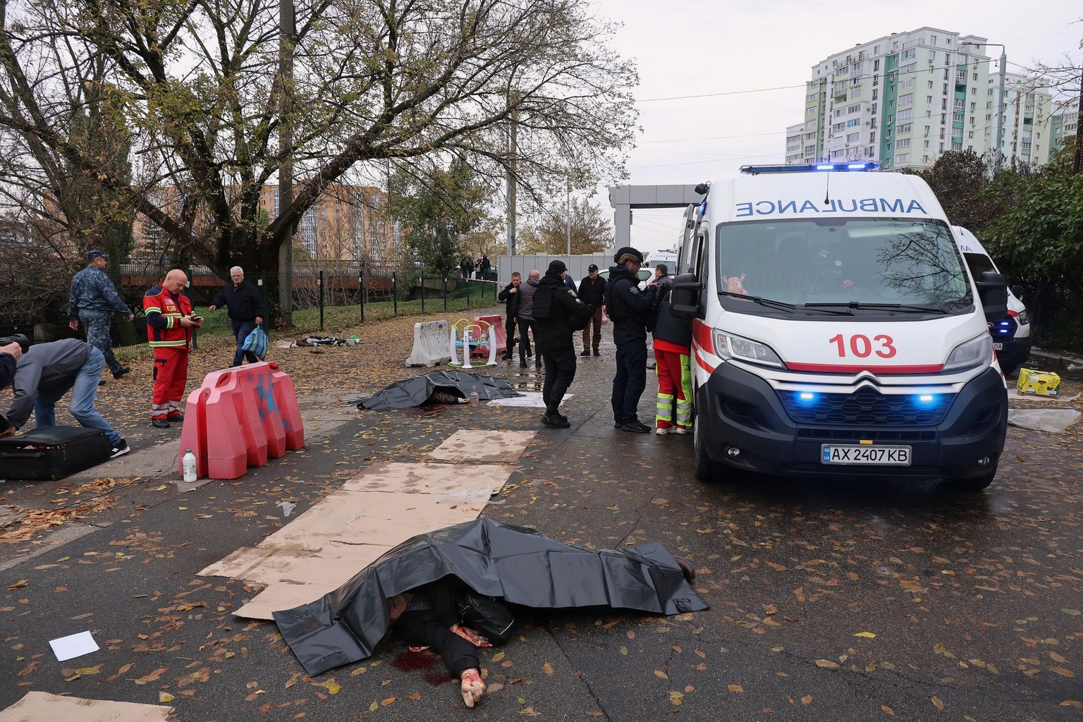 The bodies of people killed in a Russian drone attack lie near the Central Market in Kharkiv, Ukraine, on Oct. 16, 2026.