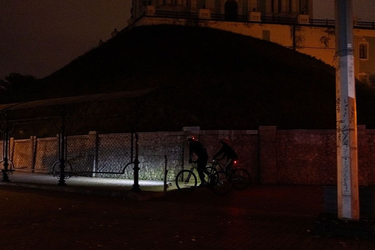 People ride bicycles near St. Andrew's Church in Kyiv.