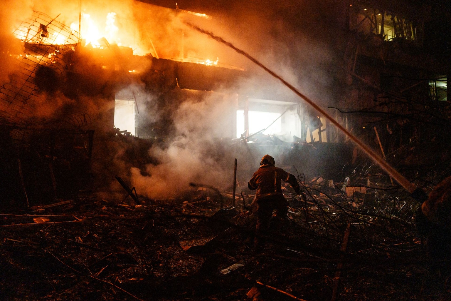 First responders work at the site of a residential building struck by Russian missile in Kyiv, Ukraine, late on Oct. 13, 2026.