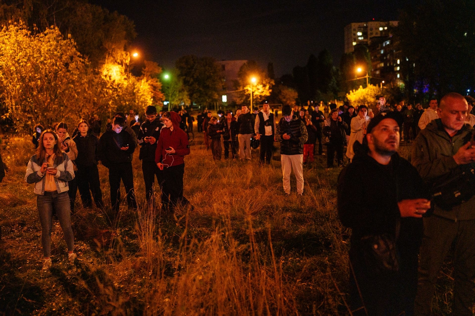 Kyiv residents gather in the aftermath of a Russian missile strike on an apartment building in Kyiv, Ukraine, on Oct. 13, 2026.